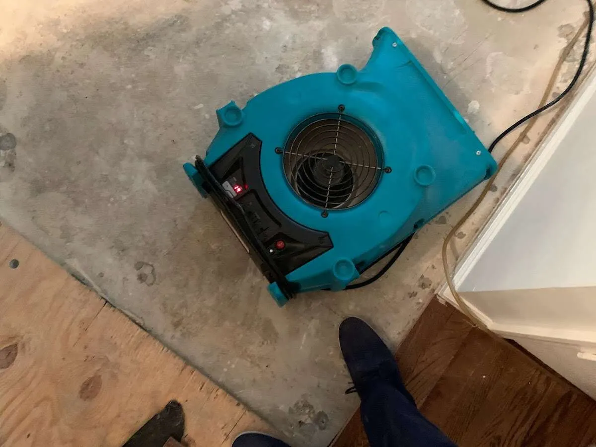 Air mover drying subfloor during Commercial Water Damage Restoration in Middle River
